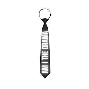 May include: Black tie with the text "AM I THE DRAMA" in white. The tie has a loop at the top for easy wear. The text is vertically aligned on the tie.