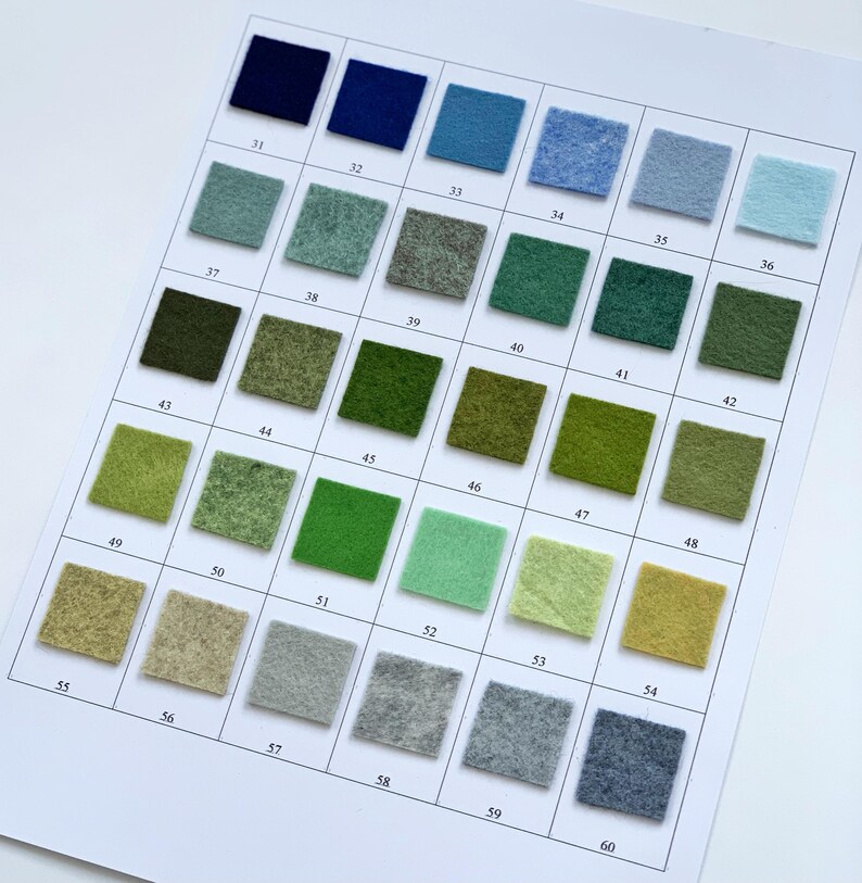 May include: A color chart featuring 30 square felt swatches in various shades of blue, green, and neutral tones. Each swatch is numbered from 31 to 60. The chart is printed on white paper, providing a visual guide for color selection.