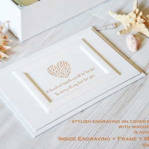 May include: White wooden box with a heart made of small gold hearts and the inscription "A hundred hearts would be too few to carry all my love for you."  The box has a wooden frame and is available with magnets.