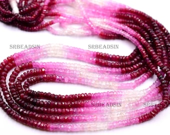 May include: A strand of faceted ruby beads in shades of pink, red, and white. The beads are graduated in size, with the largest beads at the bottom of the strand. The beads are strung on a clear thread. The strand is approximately 18 inches long. SRBEADSIN is printed on the strand.