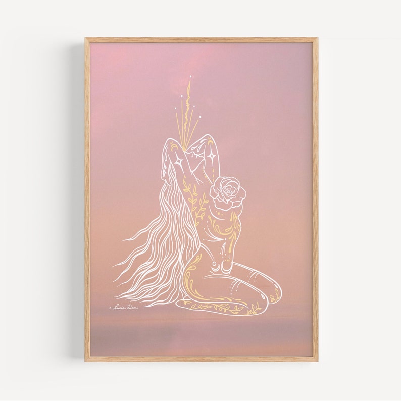 May include: A line drawing of a woman with long flowing hair, kneeling with her arms raised above her head. The woman is outlined in white and has gold floral details. The background is a soft pink gradient.