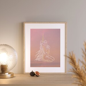 May include: A framed print of a line drawing of a woman holding a child, set against a pink and orange gradient background. The drawing is in white and gold.