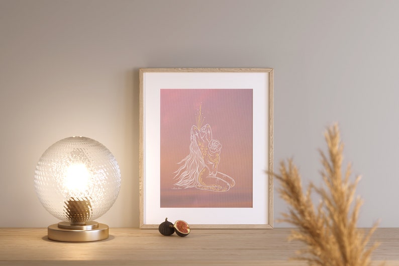 May include: A framed print of a line drawing of a woman holding a child, set against a pink and orange gradient background. The drawing is in white and gold.