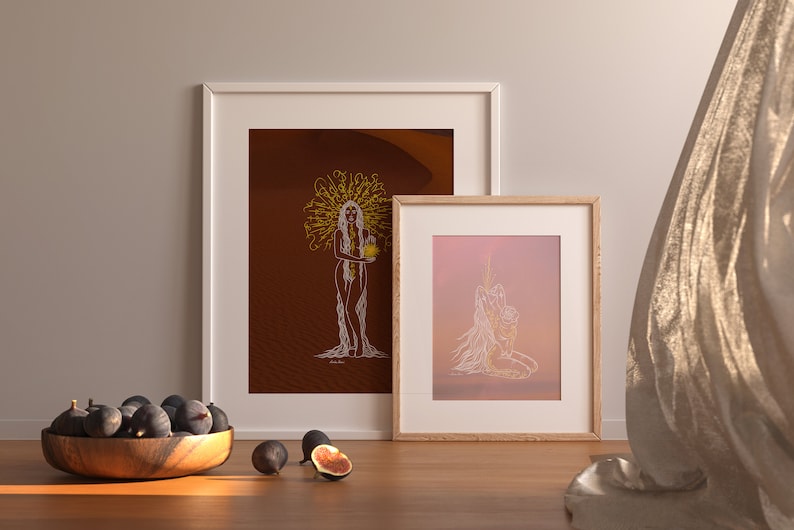 May include: Two framed illustrations of a woman with long hair, one with a desert background and the other with a pink and orange gradient background. Both illustrations are in white line art style.