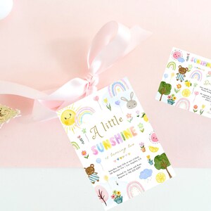 May include: A white card with a colorful rainbow, sun, and flowers design. The text on the card reads "A little sunshine is coming soon".