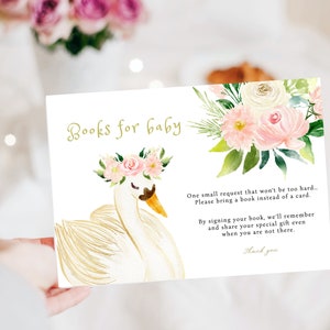 May include: A white swan with a pink floral crown on its head. The swan is on a white background with a floral design and the text "Books for baby". The text below the swan reads "One small request that won't be too hard... Please bring a book instead of a card. By signing your book, we'll remember and share your special gift even when you are not there. Thank you."