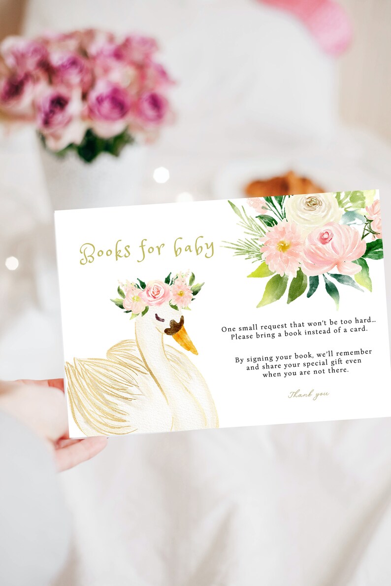 May include: A white swan with a pink floral crown on its head. The swan is on a white background with a floral design and the text "Books for baby". The text below the swan reads "One small request that won't be too hard... Please bring a book instead of a card. By signing your book, we'll remember and share your special gift even when you are not there. Thank you."