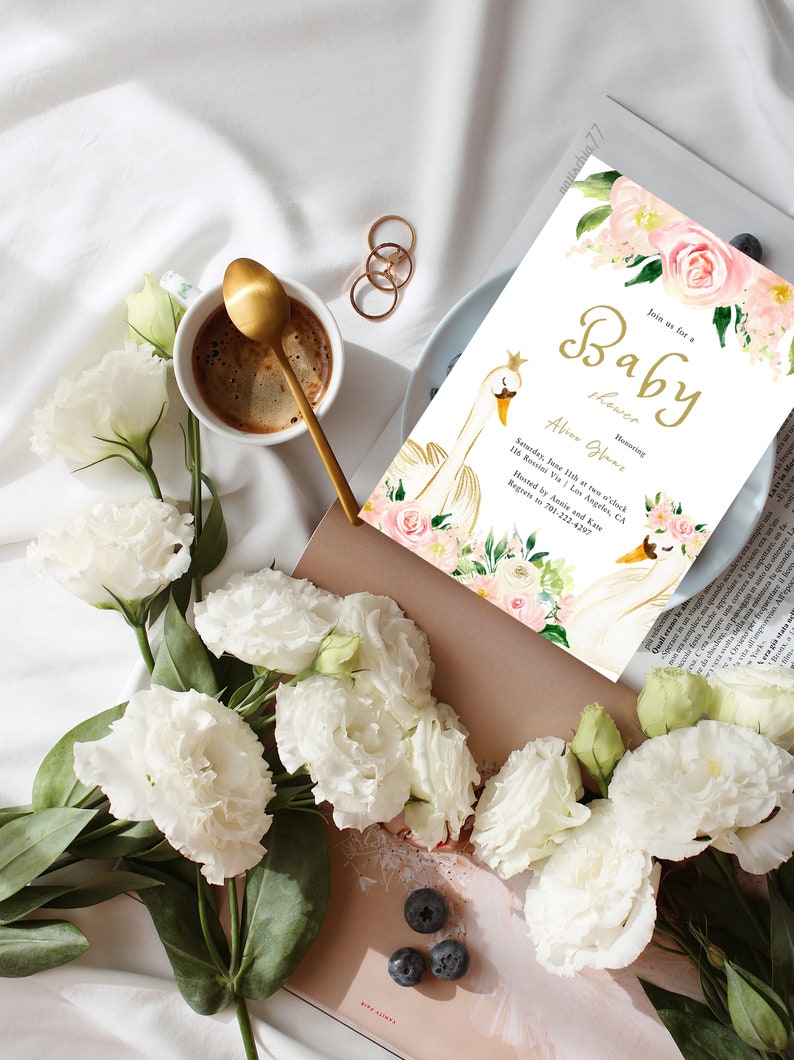 May include: A white and gold baby shower invitation with a swan design and pink floral accents. The text reads "Join us for a Baby Shower Honoring Abion Gleas. Saturday, June 11th at two o'clock 116 Rossini Via | Los Angeles, CA Hosted by Annie and Kate. Regrets to 701-222-4297"