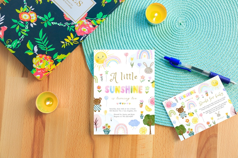 May include: A colorful invitation for a second birthday party with a sun, rainbow, and teddy bear theme. The invitation says "A little sunshine is turning two".