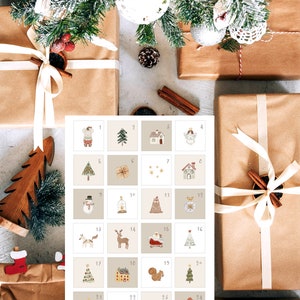May include: A printable Christmas advent calendar with 24 numbered squares, each featuring a different festive illustration. The illustrations include a snowman, a reindeer, a Christmas tree, a house, a bell, a star, and a squirrel.