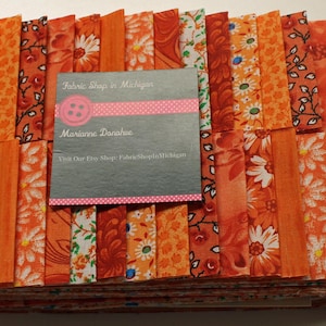 Jelly Roll Prints Oranges MDG  Jelly Roll, 40 strips Flat Folded 2 1/2 x 45 " 100 percent  Quality Cotton.
