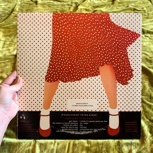 May include: A red and white polka dot vinyl record with a red dress and white shoes on the cover. The text on the cover reads "side one side two" and includes song titles like "get closer", "the moon is a harsh mistress", "I think it's gonna work out fine", "mr. radio", "lies", "tell him", "easy for you to say", "sometimes you just can't win", "people gonna talk", "my blue tears".