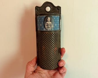 Antique metal nutmeg grater with girls picture