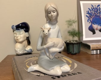 Beautiful vintage porcelain figure of serene girl holding a fawn