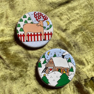 Pair of vintage Lillian Vernon stoneware ceramic Christmas holiday refrigerator magnets reindeer snowy cabin trees kitchen decor