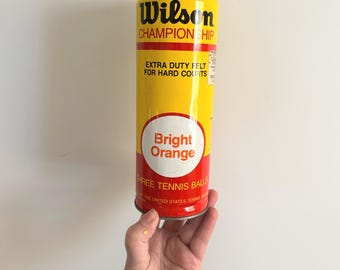 Vintage unopened Wilson Championship bright orange tennis balls in metal can