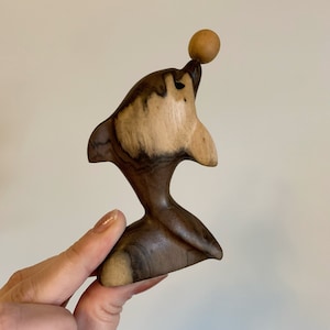 Vintage hand carved wood dolphin balancing ball
