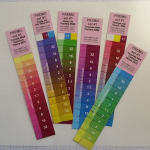 May include: A set of 6 color mixing charts for polymer clay. Each chart shows a different color mixed with white in various ratios, from 1:1 to 32:1. The colors are fuchsia, purple, green, turquoise, orange, and turquoise with cadmium yellow.