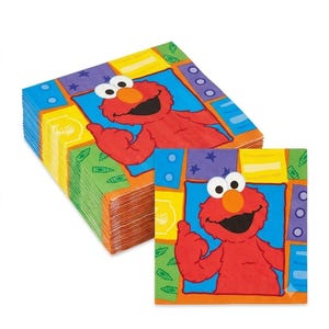 May include: A stack of square paper napkins featuring a red Elmo character on a blue background, surrounded by a colorful border of yellow, green, and purple geometric shapes with small star, circle, and crayon patterns printed on the surface.