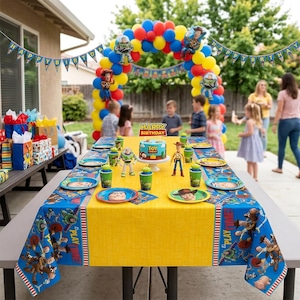 May include: A Toy Story themed birthday party setup featuring a yellow and blue tablecloth with character prints, matching plates, cups, and a central cake. An arch of red, yellow, and blue balloons stands behind the table with a Happy Birthday banner.