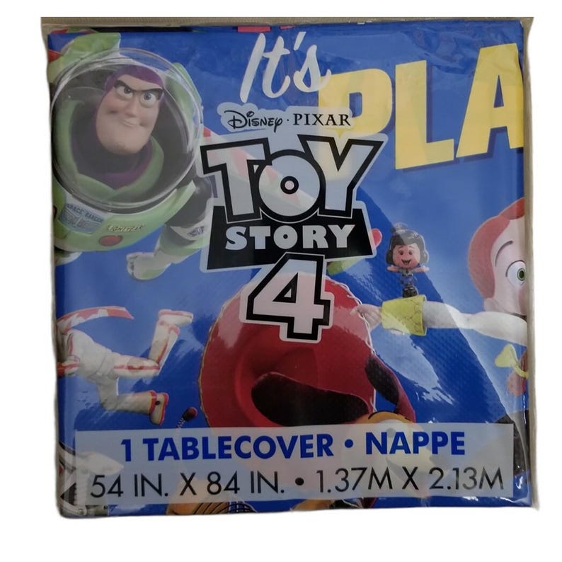 May include: A blue plastic tablecover featuring Disney Pixar Toy Story 4 characters including Buzz Lightyear and Jessie. The packaging displays the text It's Toy Story 4, 1 Tablecover, and dimensions of 54 in. x 84 in. or 1.37m x 2.13m.