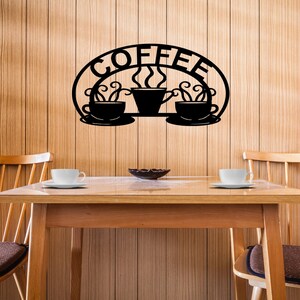 May include: Black metal wall art featuring the word "COFFEE" in a curved arch with three stylized coffee cups and steam rising from the center cup.