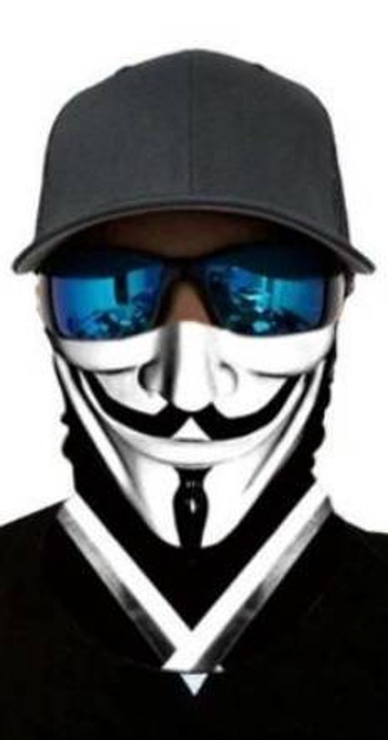 May include: A black and white face mask with a stylized image of the Guy Fawkes mask. The mask has a black and white design with a white smile and a black tie. The mask is worn by a person wearing a black baseball cap and blue sunglasses.