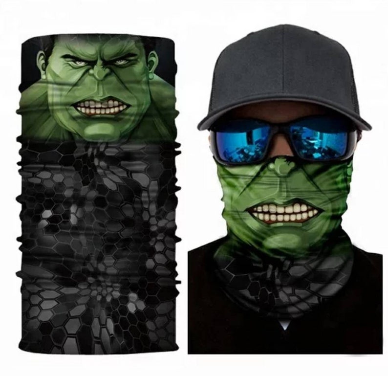 May include: A green and black face mask with a graphic of the Hulk's face. The mask is made of a stretchy fabric and can be worn as a neck gaiter, face mask, or headband.