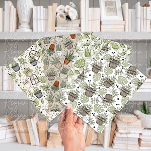 May include: Four sheets of patterned paper featuring botanical designs. The patterns include illustrations of potted plants, succulents, and leaves in shades of green, brown, and white. The papers are held in a hand against a backdrop of books and shelves.