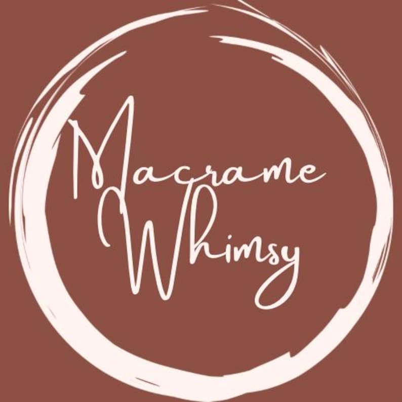 May include: A circular logo with the words "Macrame Whimsy" in white script lettering, surrounded by a white brushstroke circle, set against a brown background. The design suggests handmade crafts.
