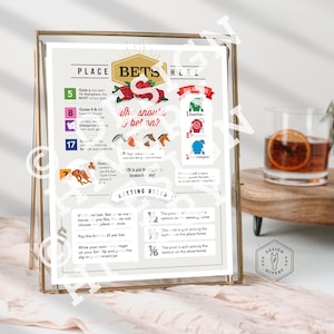 May include: A framed print with the text "PLACE BETS HERE" and horse racing information. The print includes betting rules, gate numbers, and horse illustrations. A cocktail with an orange slice sits nearby.