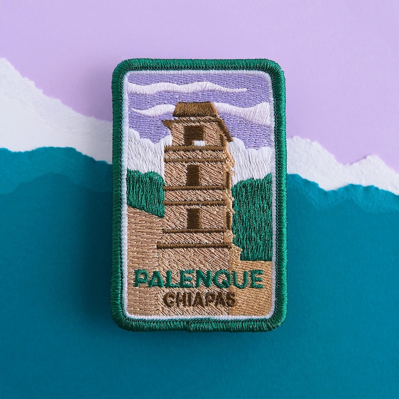 May include: Green and brown embroidered patch with a picture of a tall building with a white sky and green trees. The text "Palenque Chiapas" is embroidered on the bottom of the patch.