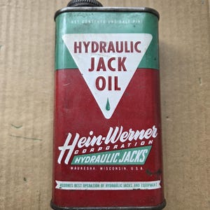 May include: Vintage Hein-Werner Hydraulic Jack Oil can. The rectangular metal can features a red and green color scheme with white text. The can reads "HYDRAULIC JACK OIL" and "Hein-Werner Corporation, Waukesha, Wisconsin, U.S.A."