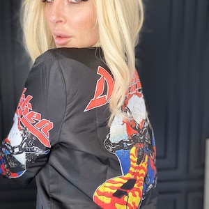 May include: Black satin bomber jacket with a colorful graphic print of a guitar and the word "Def Leppard" on the back.
