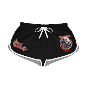 May include: Black athletic shorts with a white trim. The shorts have a white drawstring and feature a graphic of the band Iron Maiden with the text "Iron Maiden" and "Number of the Beast".