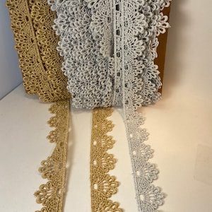 1 1/8 inch wide metallic venise lace rayon trim, sold by the yard.