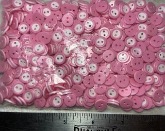 Bag of possibly thousands of pink and white  plastic buttons in excellent condition, 7/16 inch, # 901