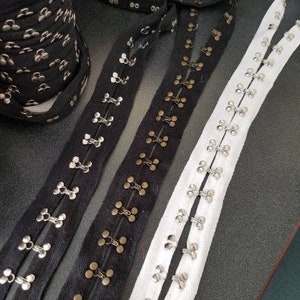 Chunky hook and eye tape fabric trim, spaced 1 inch apart, sold by the yard.