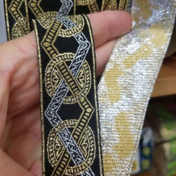 Metallic gold and black Roman style fabric trim, 1 1/8 inch wide, sold by the yard.