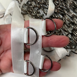 Satin lace up tape, 5/8 inch wide, large gunmetal rings, spaced 1 inch apart, sold by the yard.