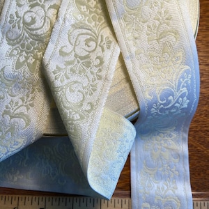 Cream on white floral Jacquard woven fabric trim,  2 1/8 inch wide, sold by the yard.