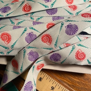 Shells and more shells, pink, purple and green jacquard fabric trim, 1 inch wide, sold by the yard.