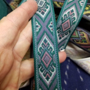 Green woven folk art jacquard fabric trim, 1 1/8 inch wide, sold by the yard.