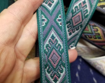 Green woven folk art jacquard fabric trim, 1 1/8 inch wide, sold by the yard.