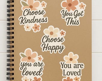 May include: A spiral-bound notebook with a kraft paper cover featuring floral stickers. The stickers have a boho design with peach and cream-colored flowers and inspirational phrases like "Choose Kindness" and "You Got This."