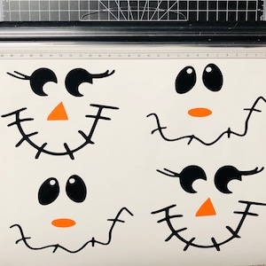 May include: Four black and white printable cutouts of cartoon faces with orange noses. The faces have different expressions, including winking, smiling, and frowning.