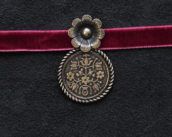Traditional Ukrainian pendant (dukach) with a flower