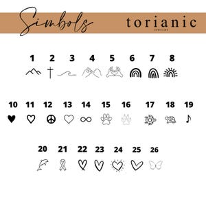 May include: A chart titled Simbols by torianic jewelry displaying twenty-six numbered black line art icons including mountains, a cross, a wave, hands, rainbows, hearts, a peace sign, infinity, paw prints, a turtle, a music note, a dolphin, and a butterfly.