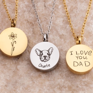 May include: Three gold necklaces with round pendants. The pendants feature a flower, a dog, and the words "I love you, Dad".
