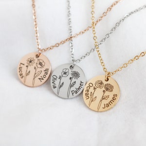 May include: Three gold necklaces with round pendants featuring engraved floral designs and names. The names on the pendants are Lucas Noah, Olivia Palmer, and Ocean James.